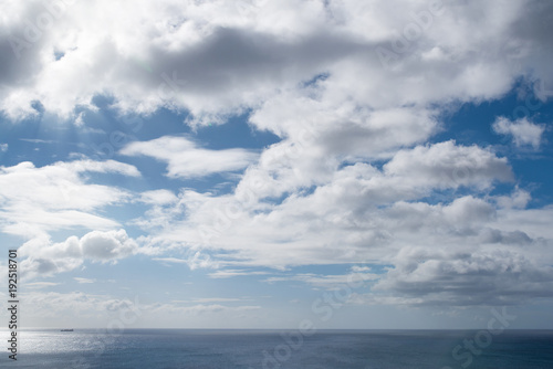 beautiful cloudscape against blue sunny sky above ocean