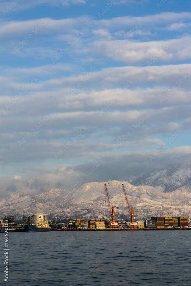 seaport and snowy mountains