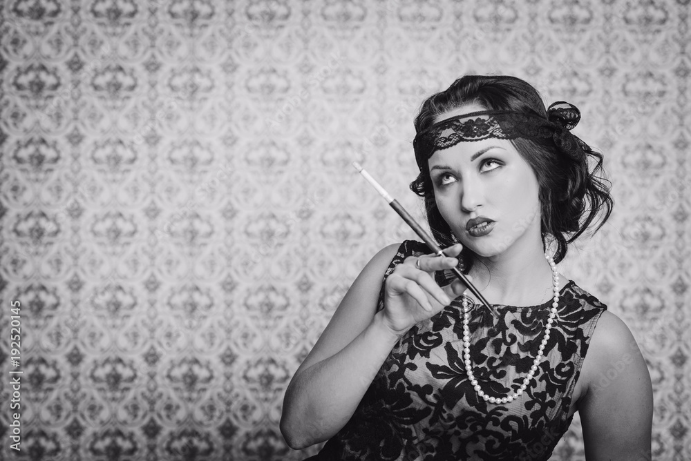 Φωτογραφία brunette girl in black dress in the style of the decadence keeps mouthpiece