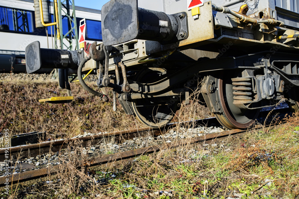 Metal wheels of a railway car standing on rails.