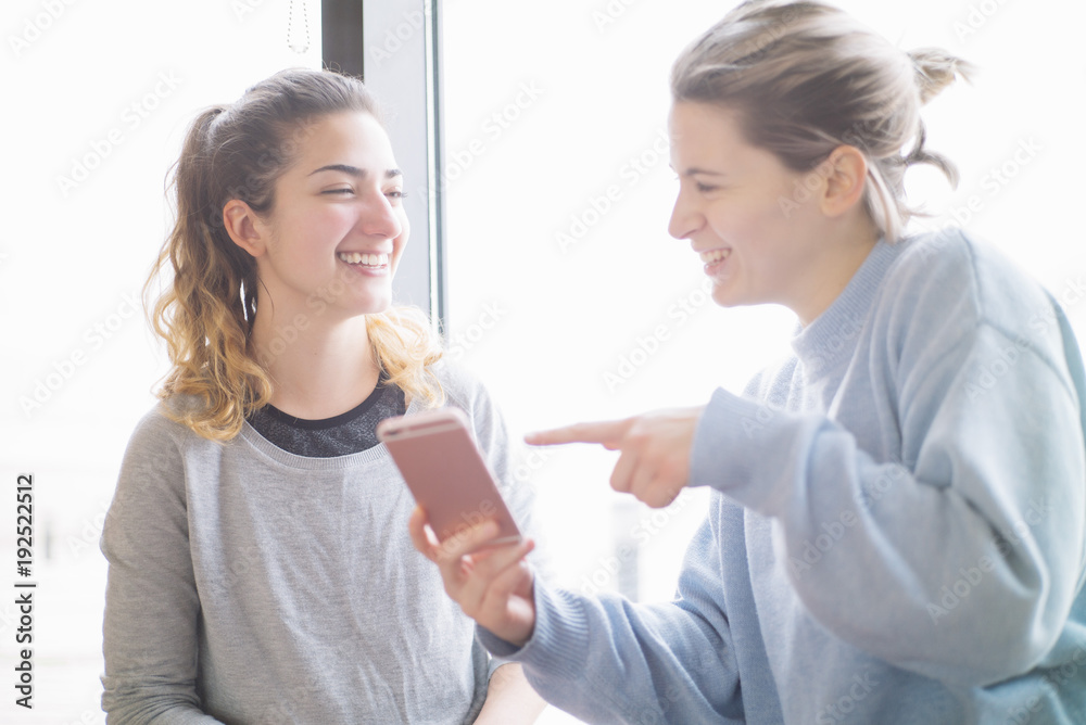 two Young woman in the gym with smartphone two Young woman in the gym with smartphone