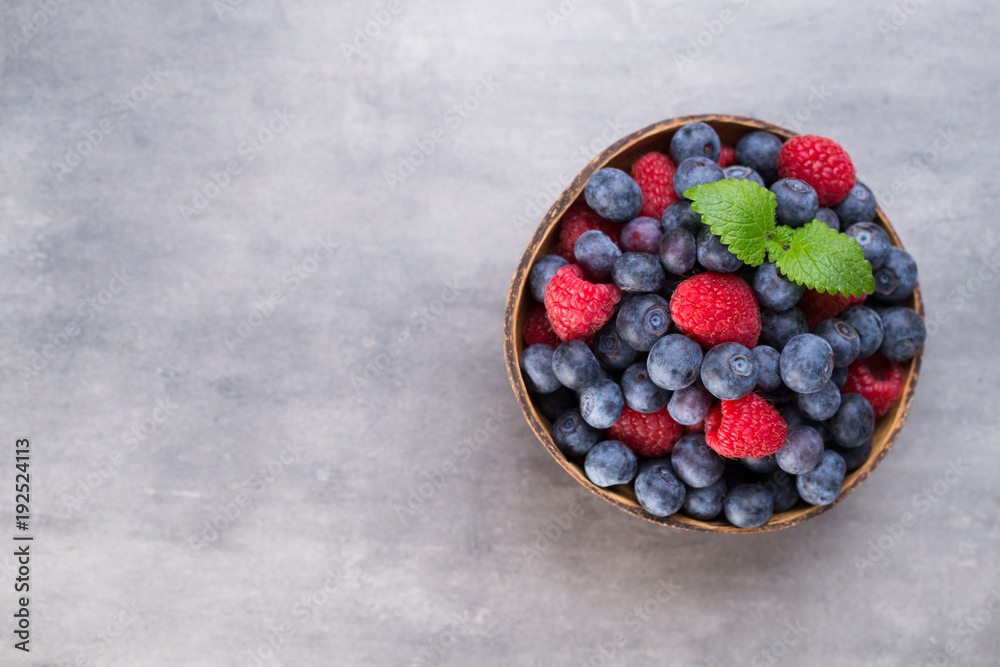 Juicy and fresh blueberries with green mint on rustic gray table. Juicy and fresh blueberries with green mint on rustic gray table.