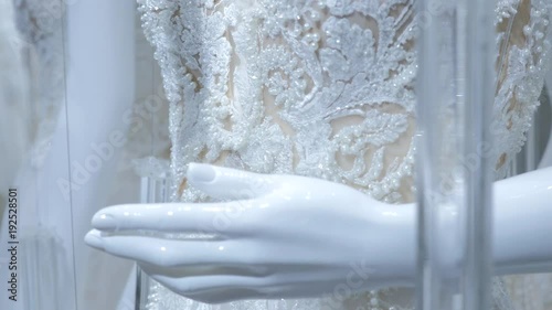 Wedding dresses in bridal boutique. Beautiful wedding dress. Close-up textile of wedding dress in boutique. Many white dresses in luxury Bridal salon.