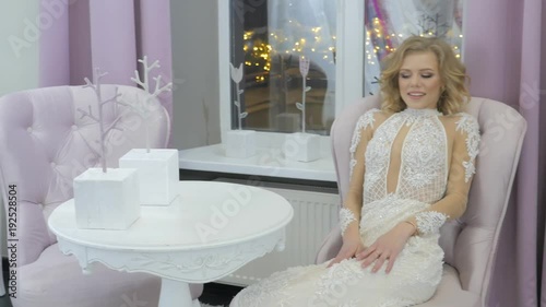 Luxury Bride dress. Bride Trying on Wedding Dress in Bridal Shop. Caucasian model in expensive white dress. Beautiful Make up on happy bride. Wedding preparation, Bachelorette party. Smiling cute girl
