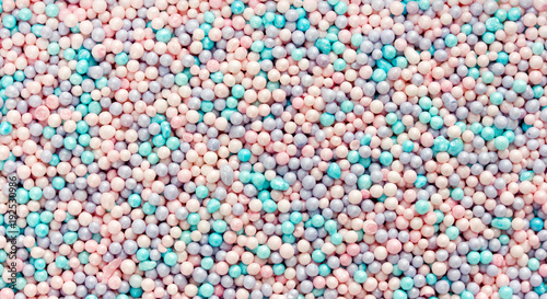 Edible pastel color confetti sprinkles for cake cookie ice cream decoration as a background