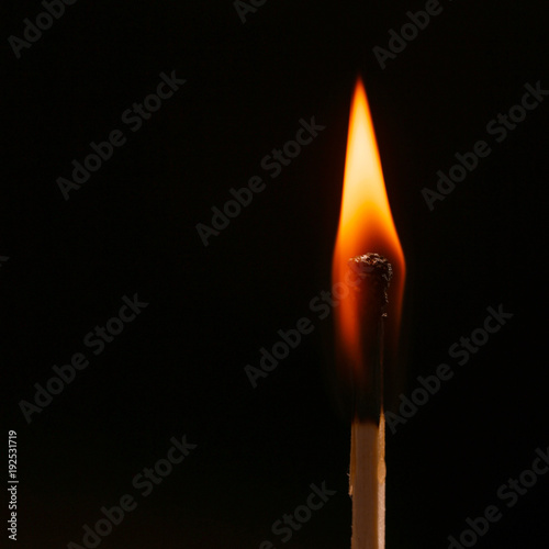 An igniting match against black background