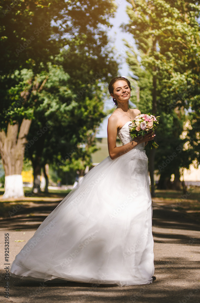 Beautiful brunette bride portrait in summer park Beautiful brunette bride portrait in summer park
