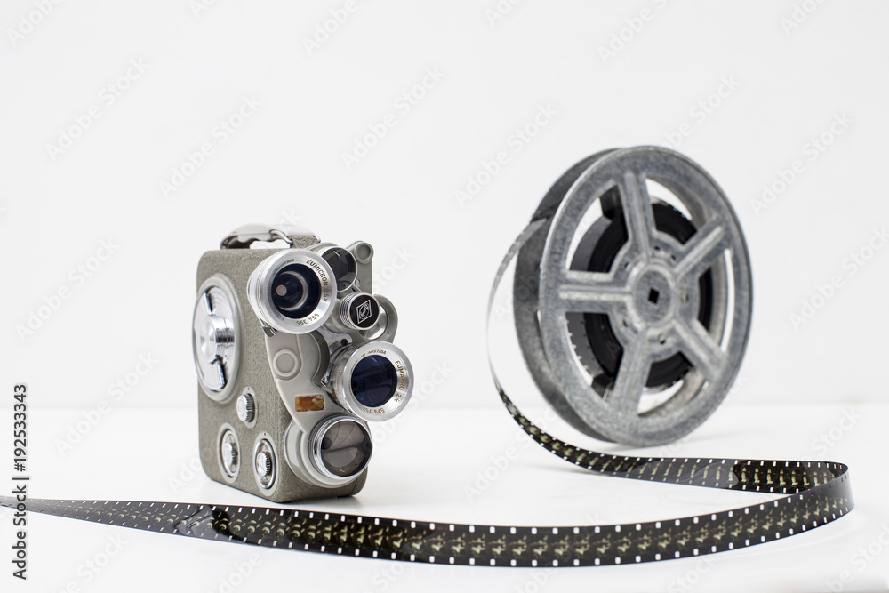 old movie camera with film reel on white background Stock Photo