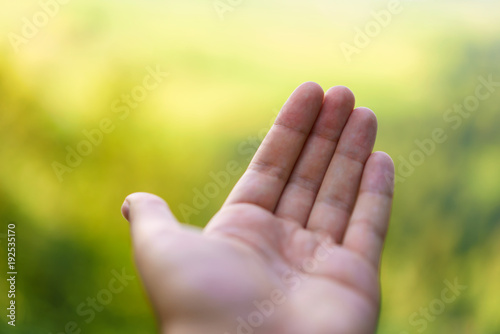 Empty Hand with blurred bokeh landscape background