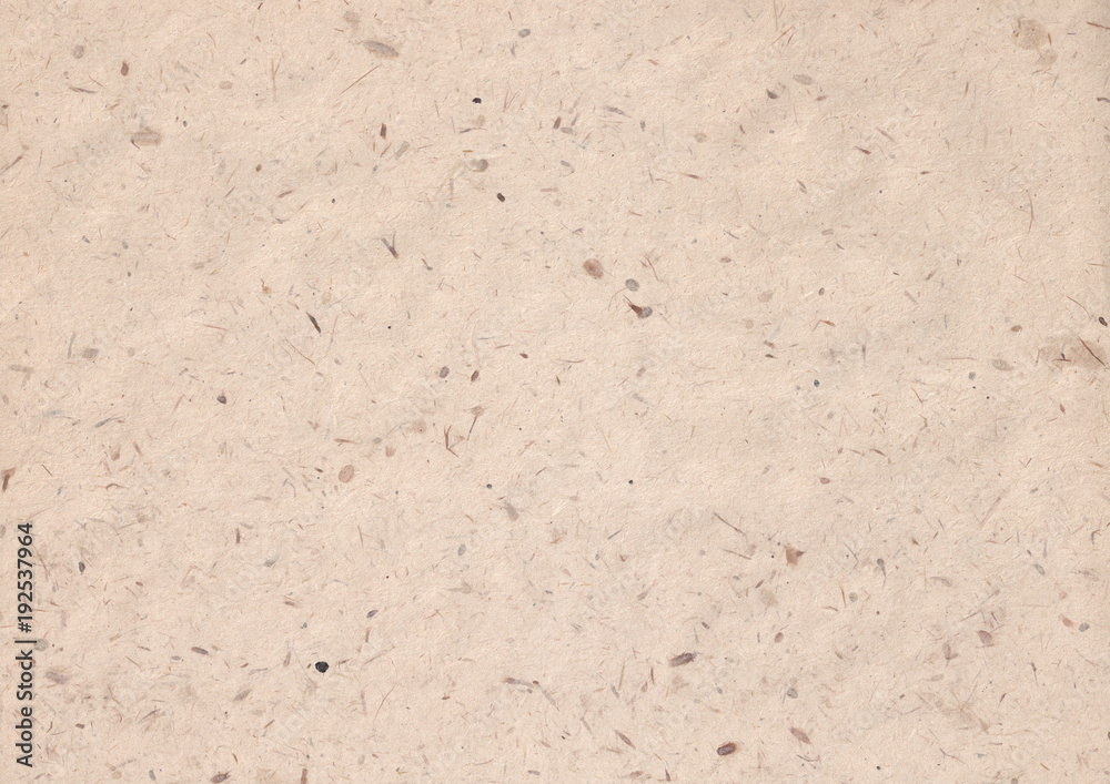 texture of kraft paper sheet with dark brown grain shavings