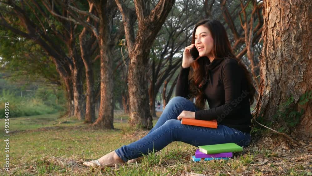 4k video of smiling woman talking on mobile phone in the park 4k video of smiling woman talking on mobile phone in the park