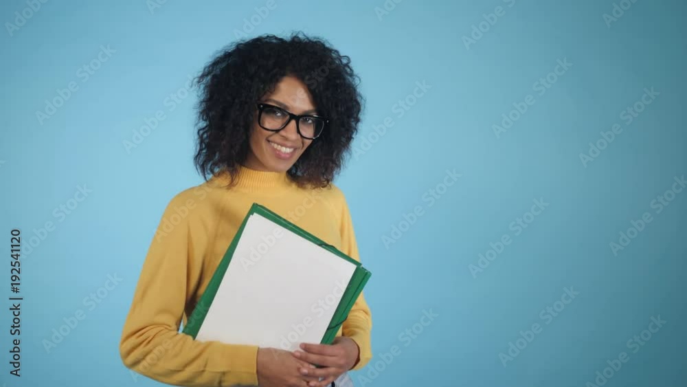 Smiling african student with folders showing OK sign. Mixed race girl in glasses, international education and people concept, 4k Smiling african student with folders showing OK sign. Mixed race girl in glasses, international education and people concept, 4k