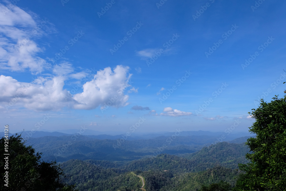 Beautiful mountain landscape, with mountain peaks covered with forest and a cloudy sky