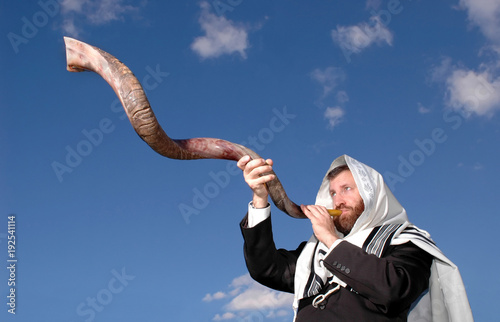 Man blowing Yemenite shofar photo