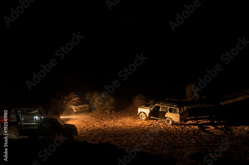 4x4 vehicles in the dark of the desert