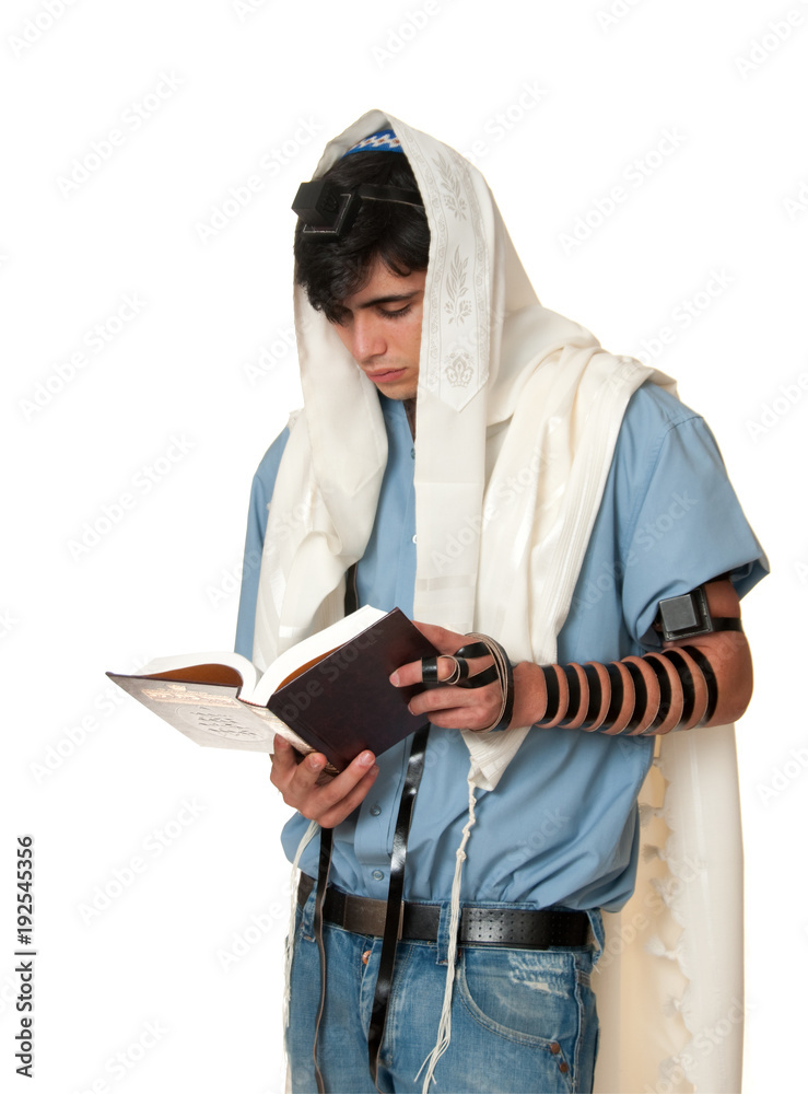 young jewish man prays wearing tallit and tefillin Stock Photo