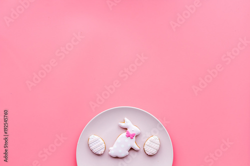 Sweets, pastry for Easter table. Easter eggs and Easter bunny concept. Pink background top view space for text © 9dreamstudio