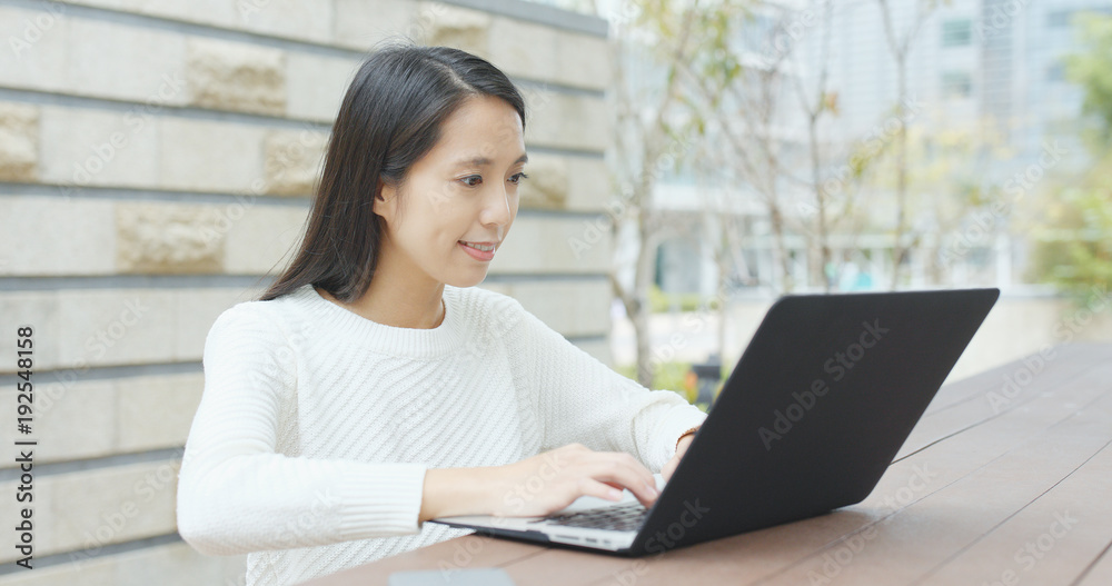 Woman working on laptop computer at outdoor Woman working on laptop computer at outdoor