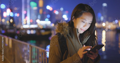 Photography Young Woman using cellphone in Hong Kong at night