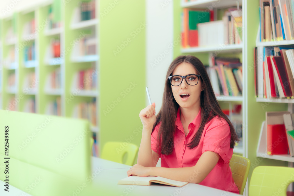 Female Student Studying and Taking Notes in the Library Female Student Studying and Taking Notes in the Library