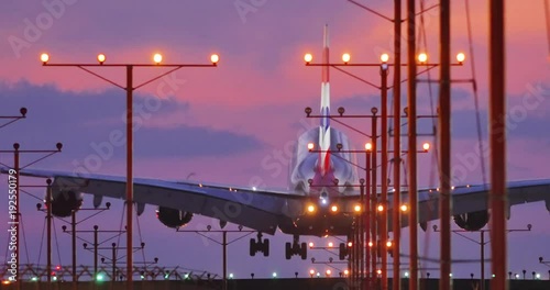 Jumbo jet airplane plane landing in airport in Los Angeles at sunset. 4K UHD