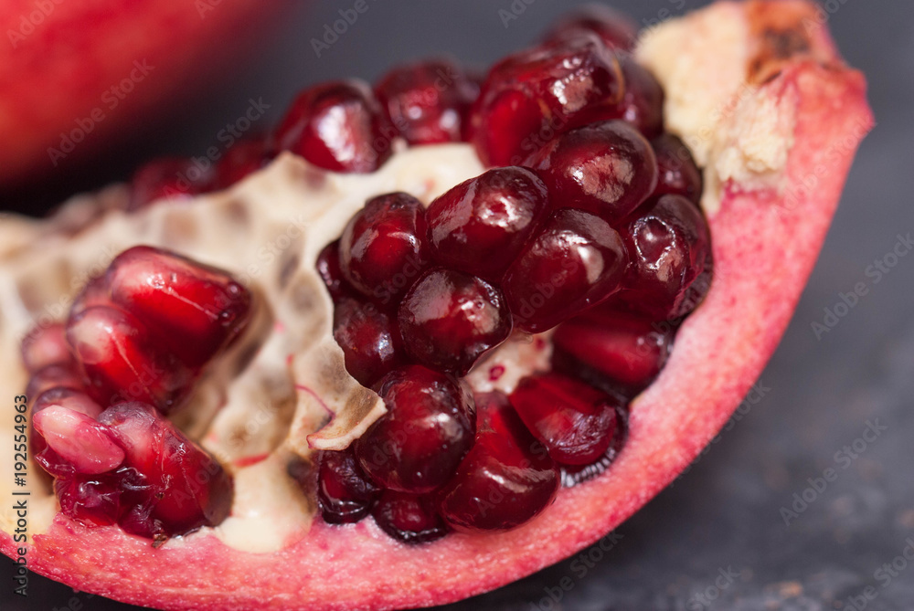 Slice of Pomegranate Fruit. Close up Granate Seeds in slice. Graz Background. Slice of Pomegranate Fruit. Close up Granate Seeds in slice. Graz Background.
