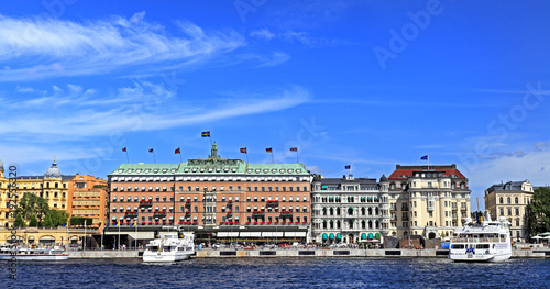 Stockholm, Sweden - Norrmalm district view from Old town quarter Gamla Stan - Baltic sea harbor piers and most prominent shoreline residences