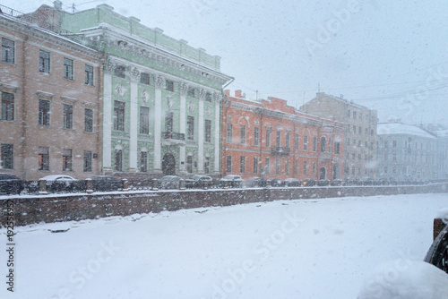 Typical for St. Petersburg, snowy and windy weather in the winter afternoon. Embankment of the snow-covered Moika River