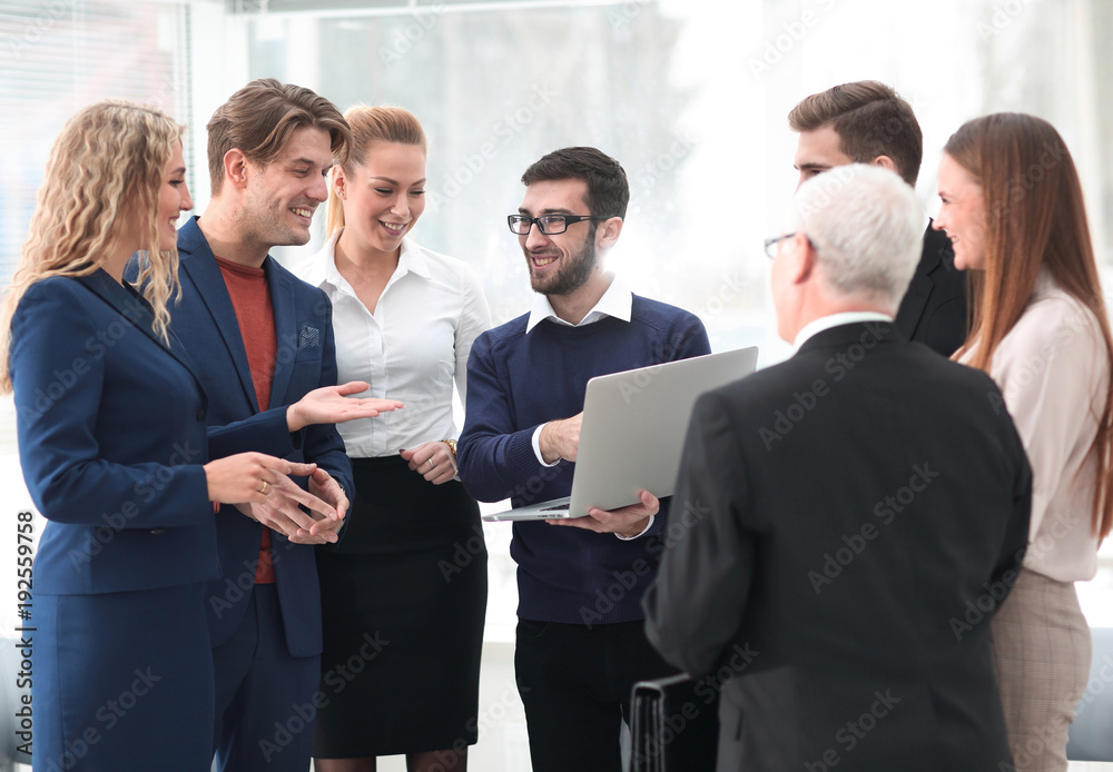 successful business team discussing documents and ideas standing near desktop successful business team discussing documents and ideas standing near desktop