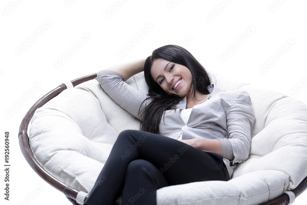 Fototapeta premium young woman sitting in a comfortable soft big armchair