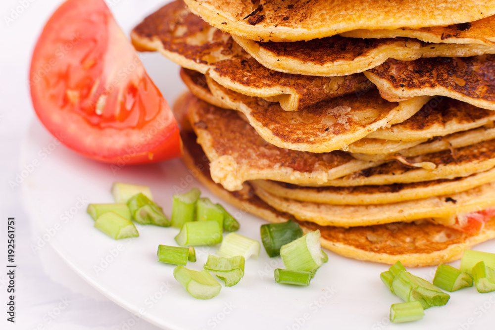 fried pancakes or fritters are stacked - a traditional dish for carnival, a serving option