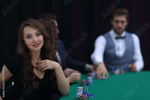 modern business woman sitting at craps table in a casino.