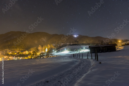 Night snowy scene in Tuhinj valley, Slovenia photo