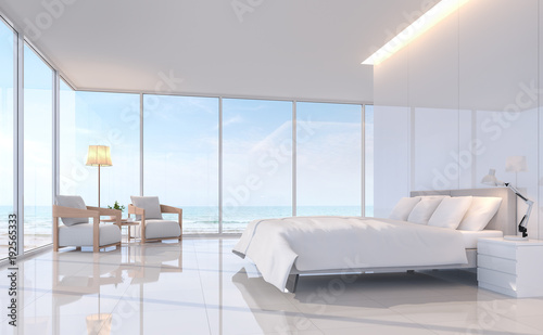 Modern white bedroom with sea view 3d rendering image.There are white tile floor and white glossy wall.Furnished with white furniture.There are large window overlooks to sea view.