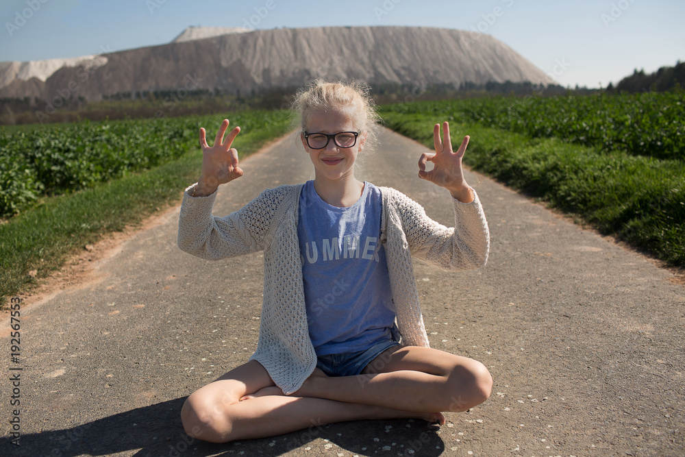 Yoga with a white hill behind 
