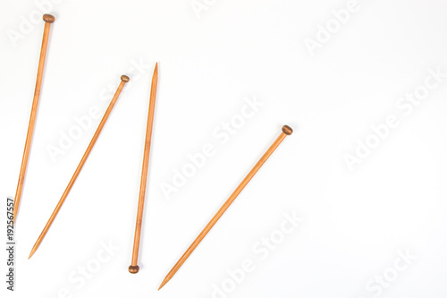Wooden knitting needles on white background as frame
