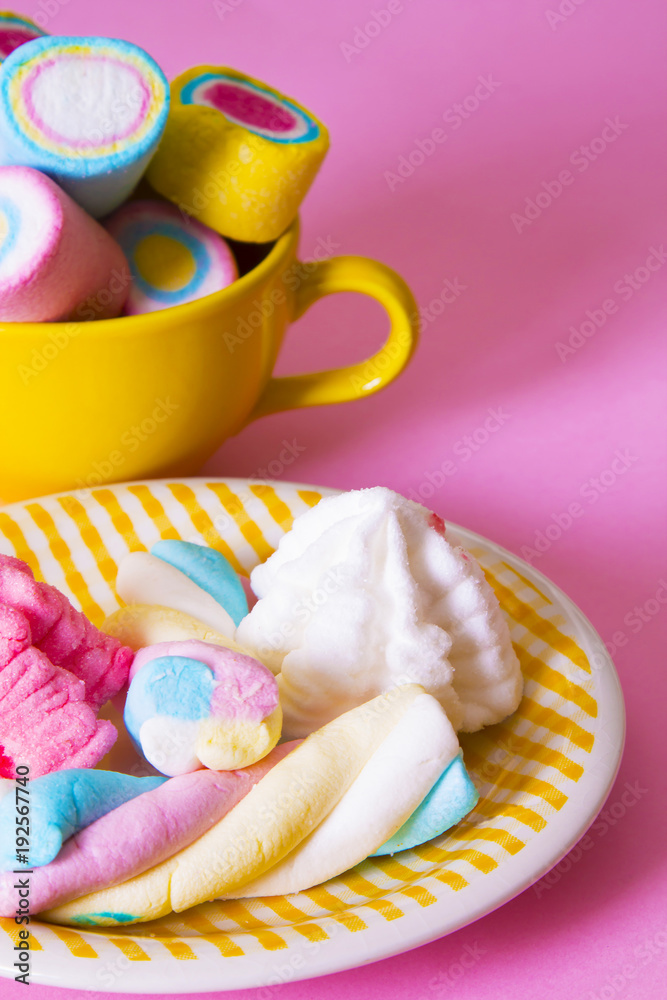 marshmallows of coloress on pink background