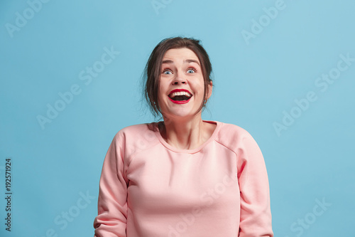 Photos Beautiful woman looking suprised isolated on blue