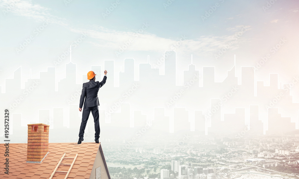 Man architect draw silhouette of modern city on blue sky. Mixed Man architect draw silhouette of modern city on blue sky. Mixed