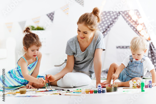 children s creativity. mother and children draw paints in   playroom