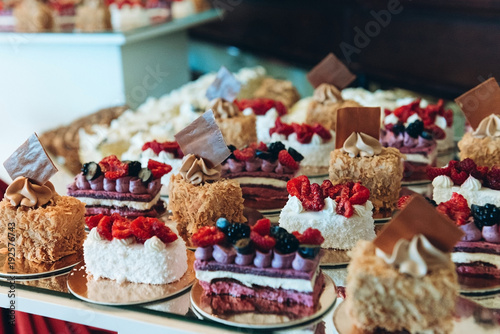 Beautiful cakes on wedding candybar table with berries, caramel and coconut