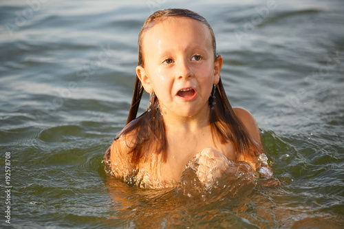 Girl having fun bathing in the sea.