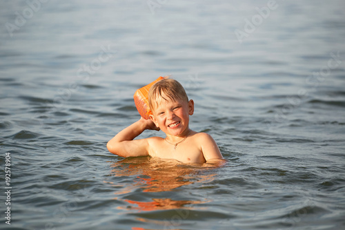 The boy is swimming in the sea.