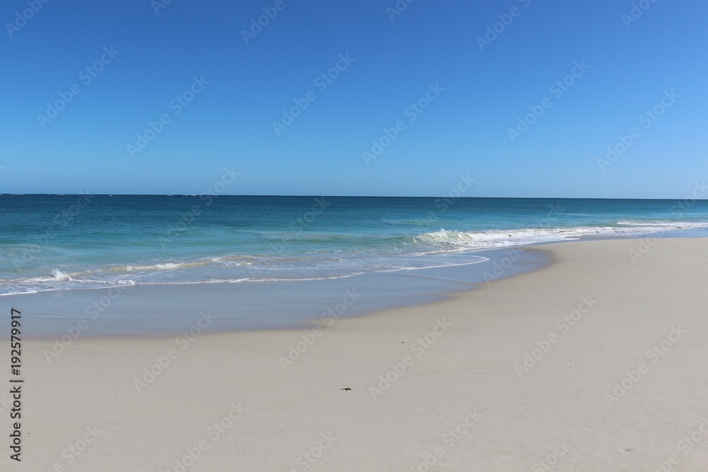 Gorgeous beach with white sand and turquoise water under blue skies
