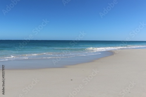 Gorgeous beach with white sand and turquoise water under blue skies