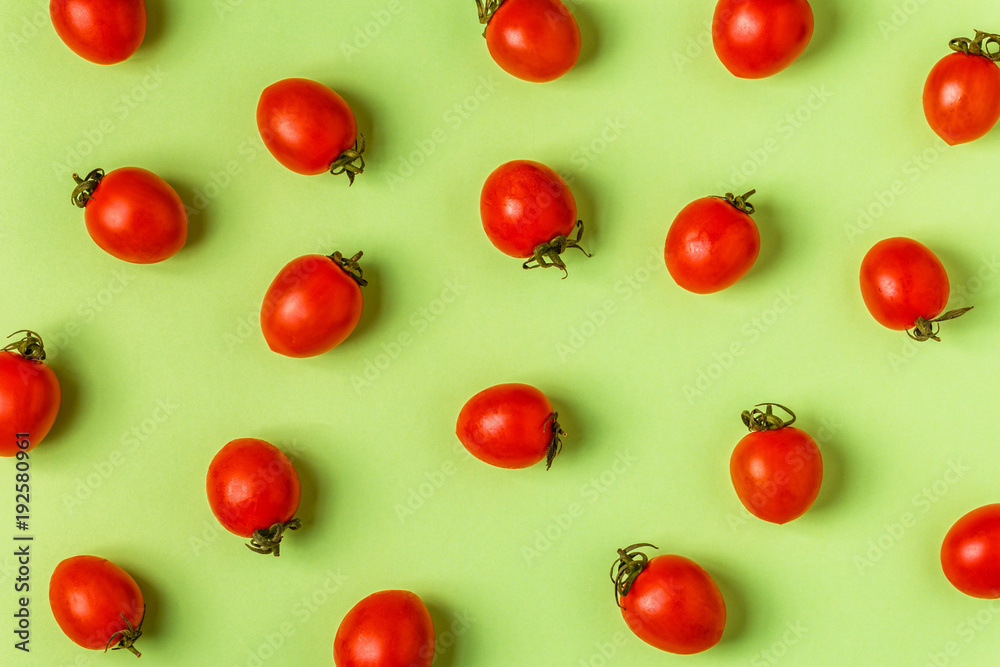 Tomatoes on a green pastel background