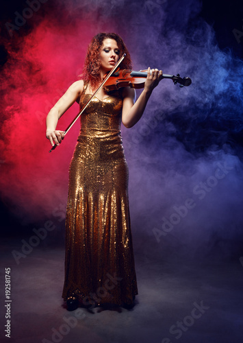 Violinist girl performs on stage. © Voloshyn Roman