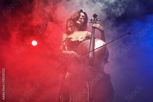The cellist girl performs on stage.