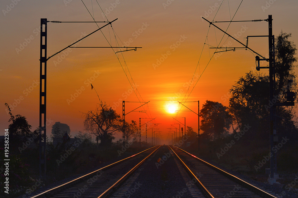 Golden railway tracks at sunrise