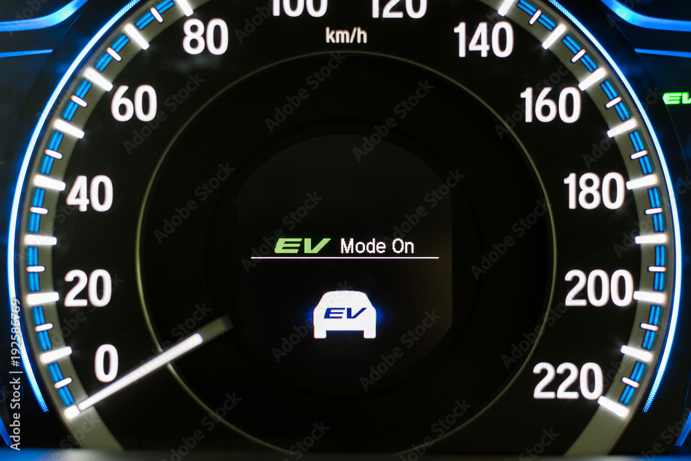 EV- Electrical vehicle mode turned on on hybrid car screen in front of steering wheel for green power fuel transportation technology, environmental eco- friendly, and saving energy concept EV- Electrical vehicle mode turned on on hybrid car screen in front of steering wheel for green power fuel transportation technology, environmental eco- friendly, and saving energy concept